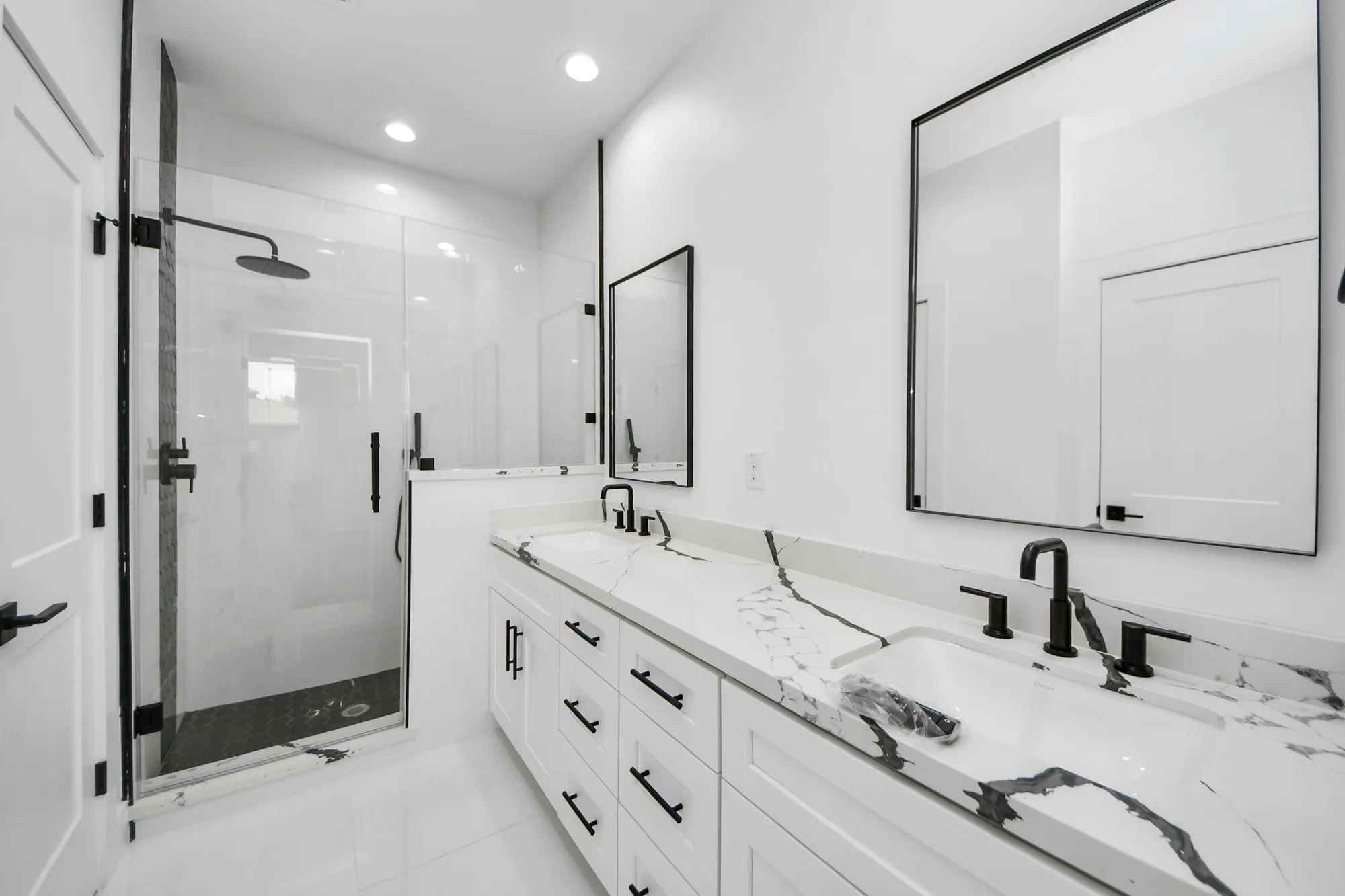 Bathroom with walk-in shower and double vanity in a Broom Street home
